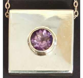 Silver pendant set with an amethyst facet stone