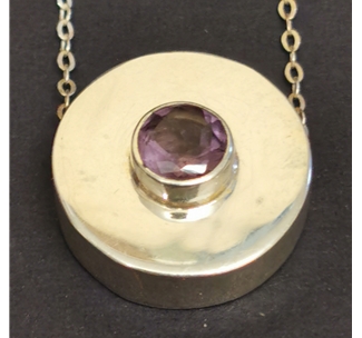 Silver pendant set with an amethyst facet stone